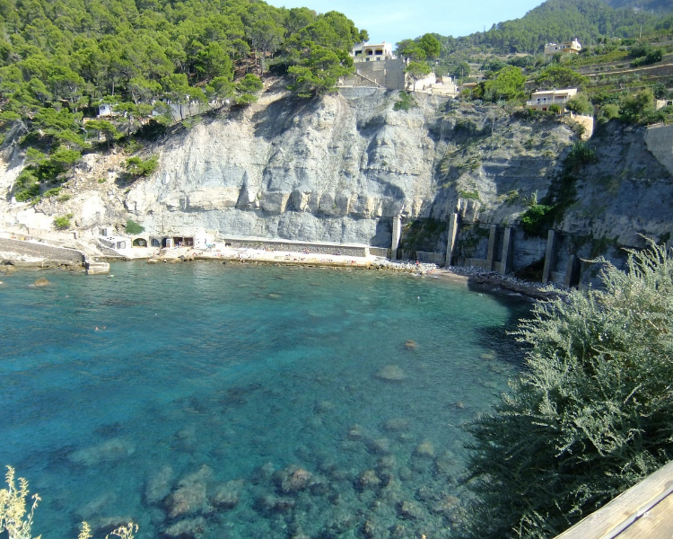 Panoramic image of Cala Banyabufar with crystal clear waters.