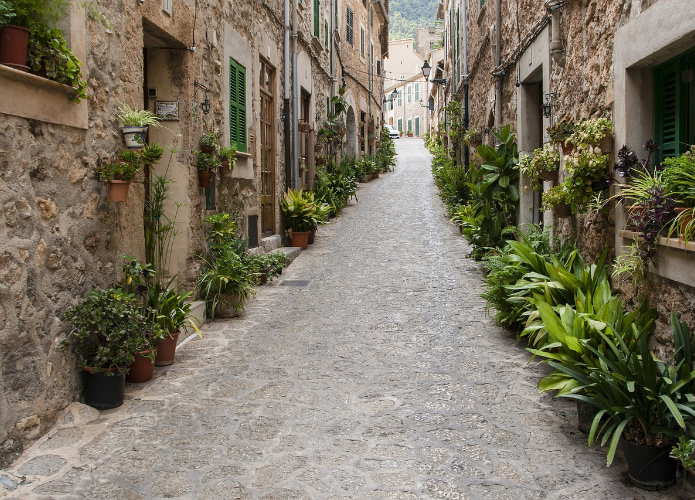 Cobblestone street decorated with plants in Valldemossa near Banyalbufar