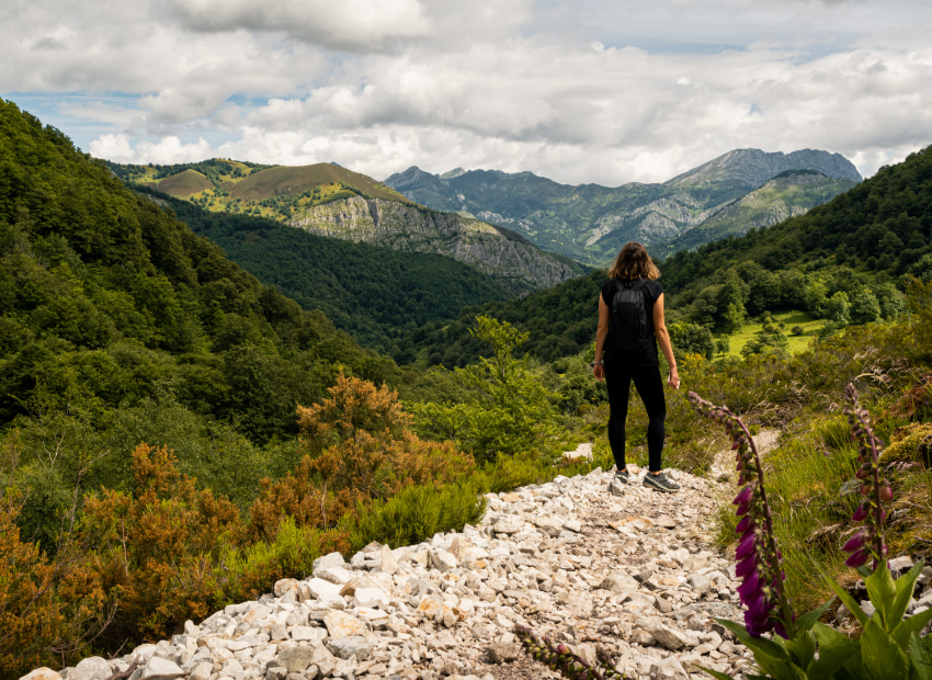 Woman hiking in the middle of the mountains