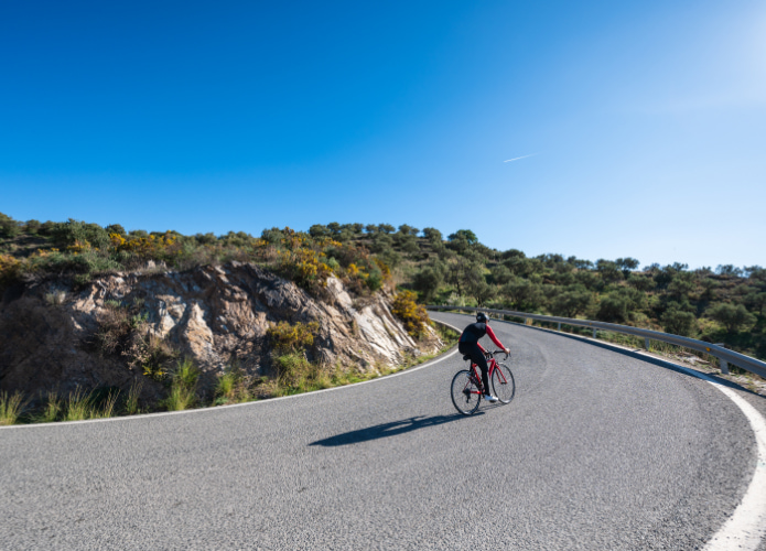 Cyclist taking a turn on a mountain road