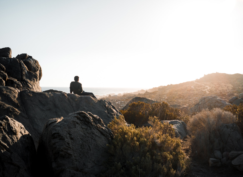 Person resting at the top of the mountain