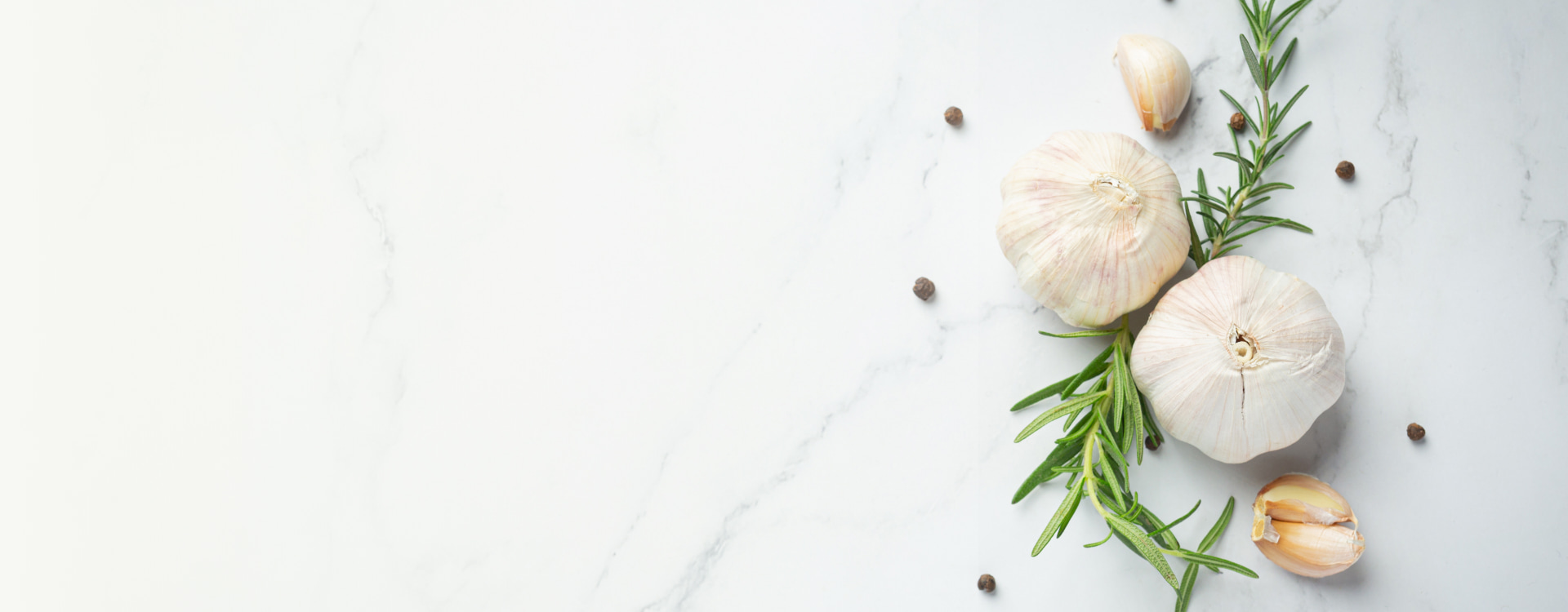 Detail of garlic and rosemary on a white background